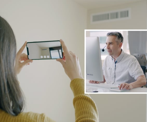 A technician uses Streem to show a customer how to fix a vent problem using remote AR-powered video