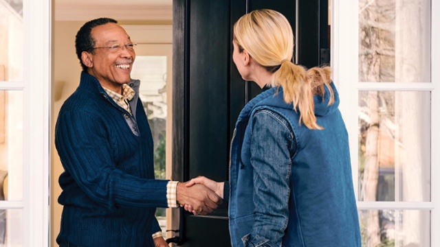 A customer and technician shake hands after a successful interaction